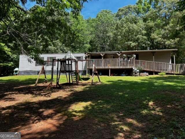 a view of a house with backyard and sitting area