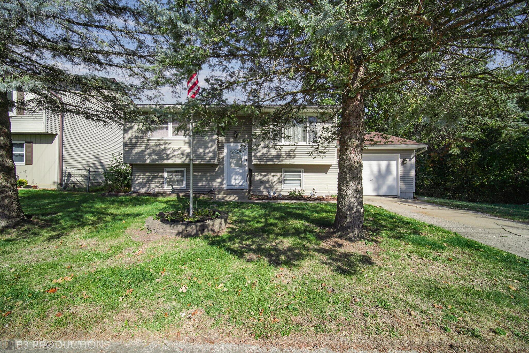 front view of a house with a tree