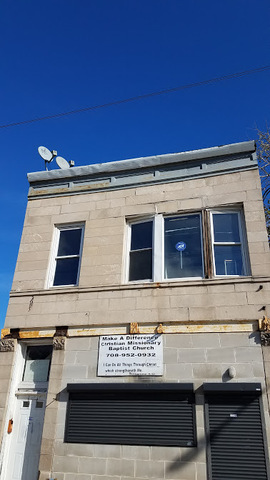 a view of a building with a door and a chair