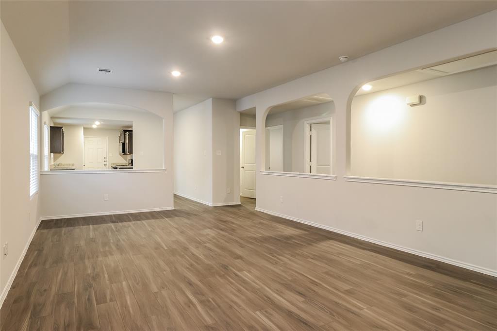 a view of an empty room and wooden floor