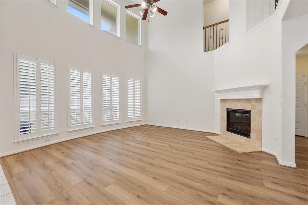 a view of an empty room with a window and fireplace