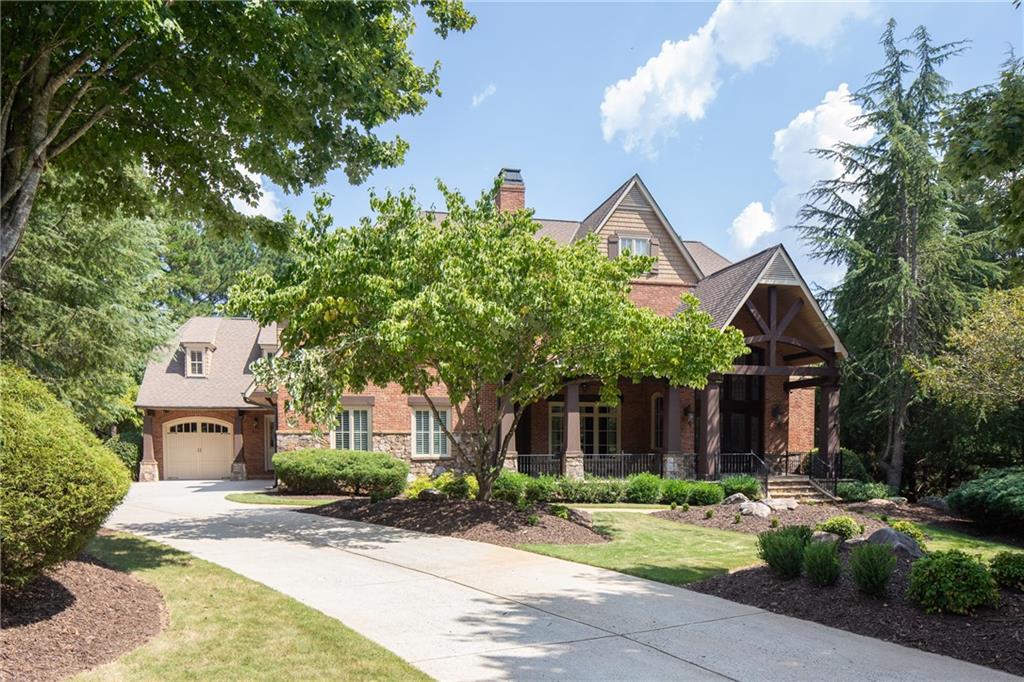 a front view of a house with a yard and fountain