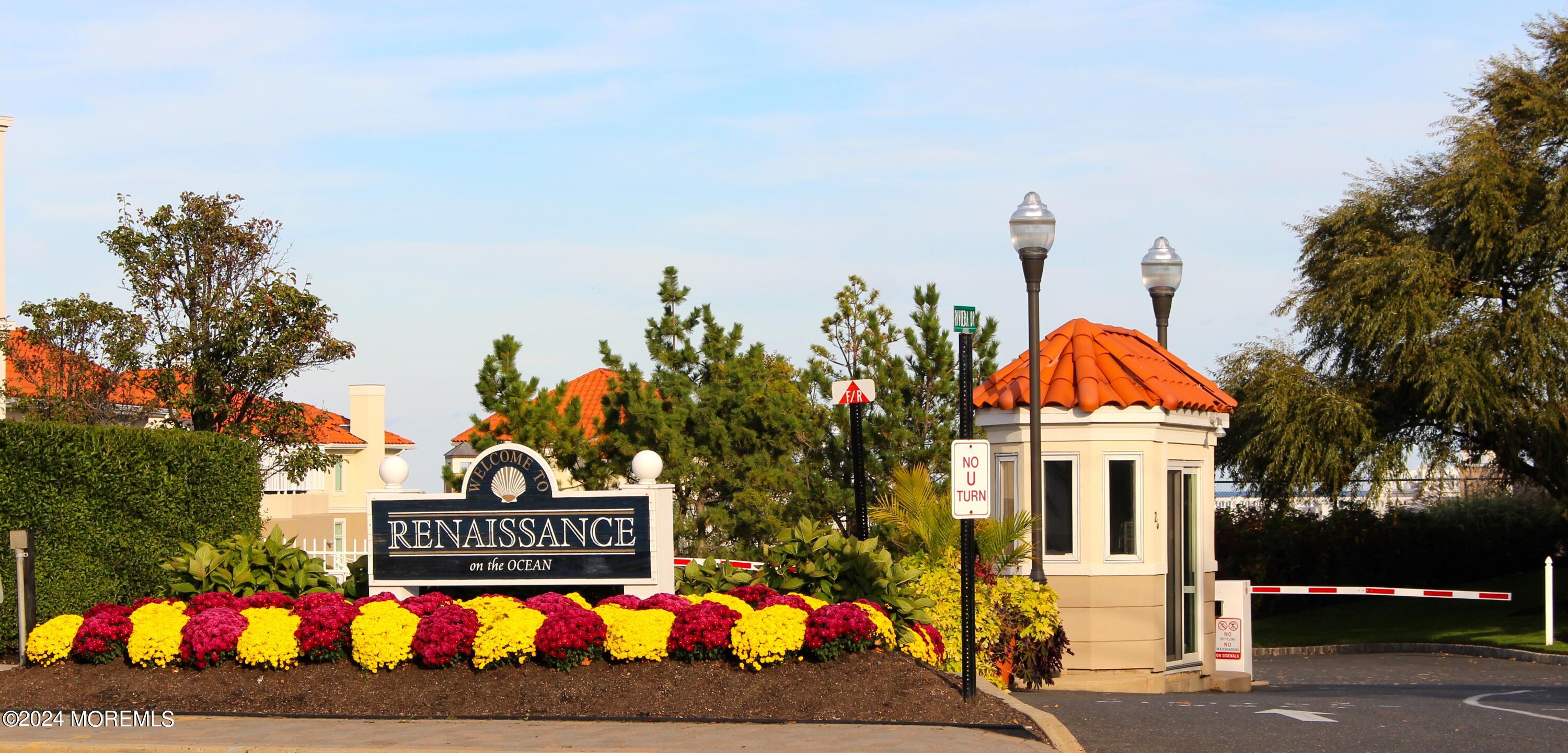 a view of sign board with buildings in the background