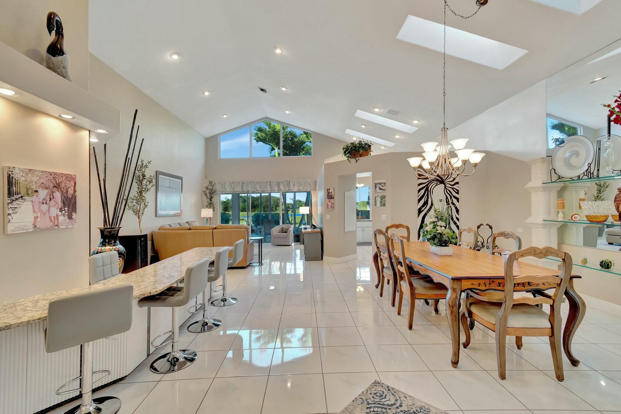 a view of a dining room with furniture a chandelier and wooden floor