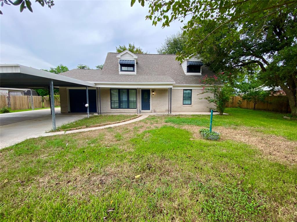 a front view of house with yard and outdoor seating