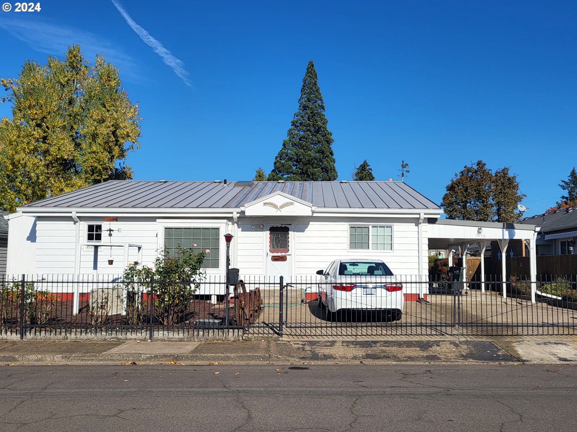 a front view of a house with a garden