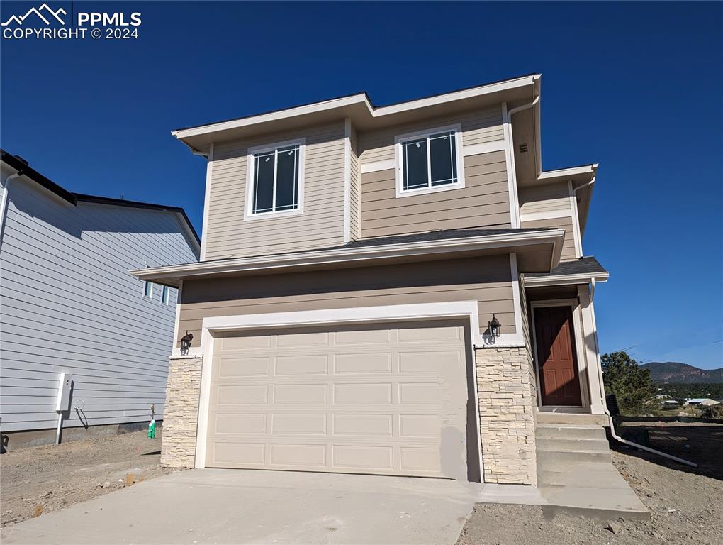 a front view of a house with a garage