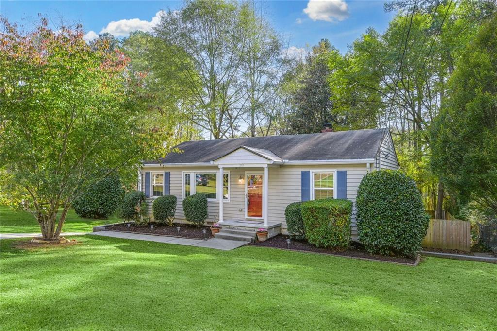 a front view of a house with a garden