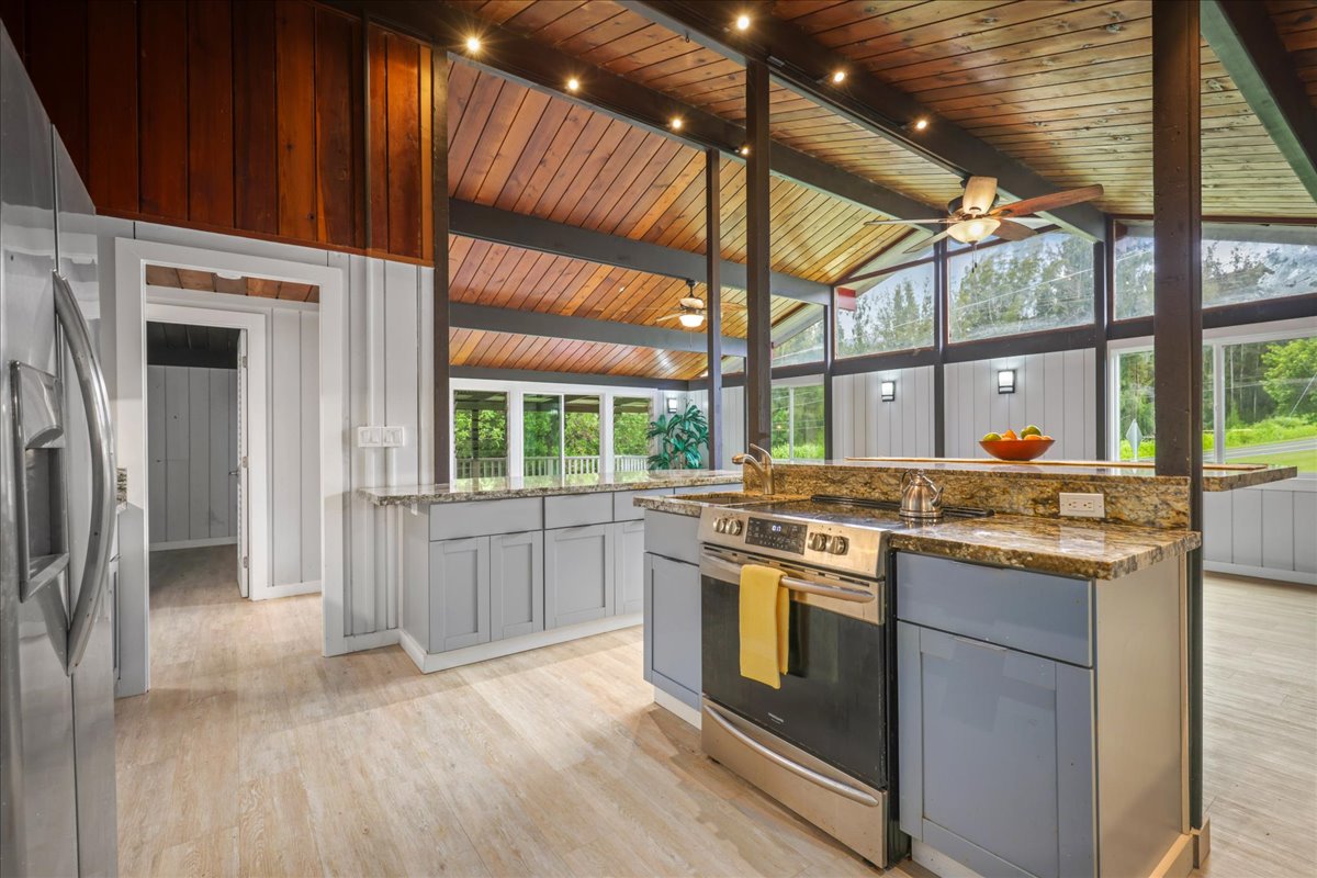 a kitchen with stainless steel appliances granite countertop a stove and a refrigerator