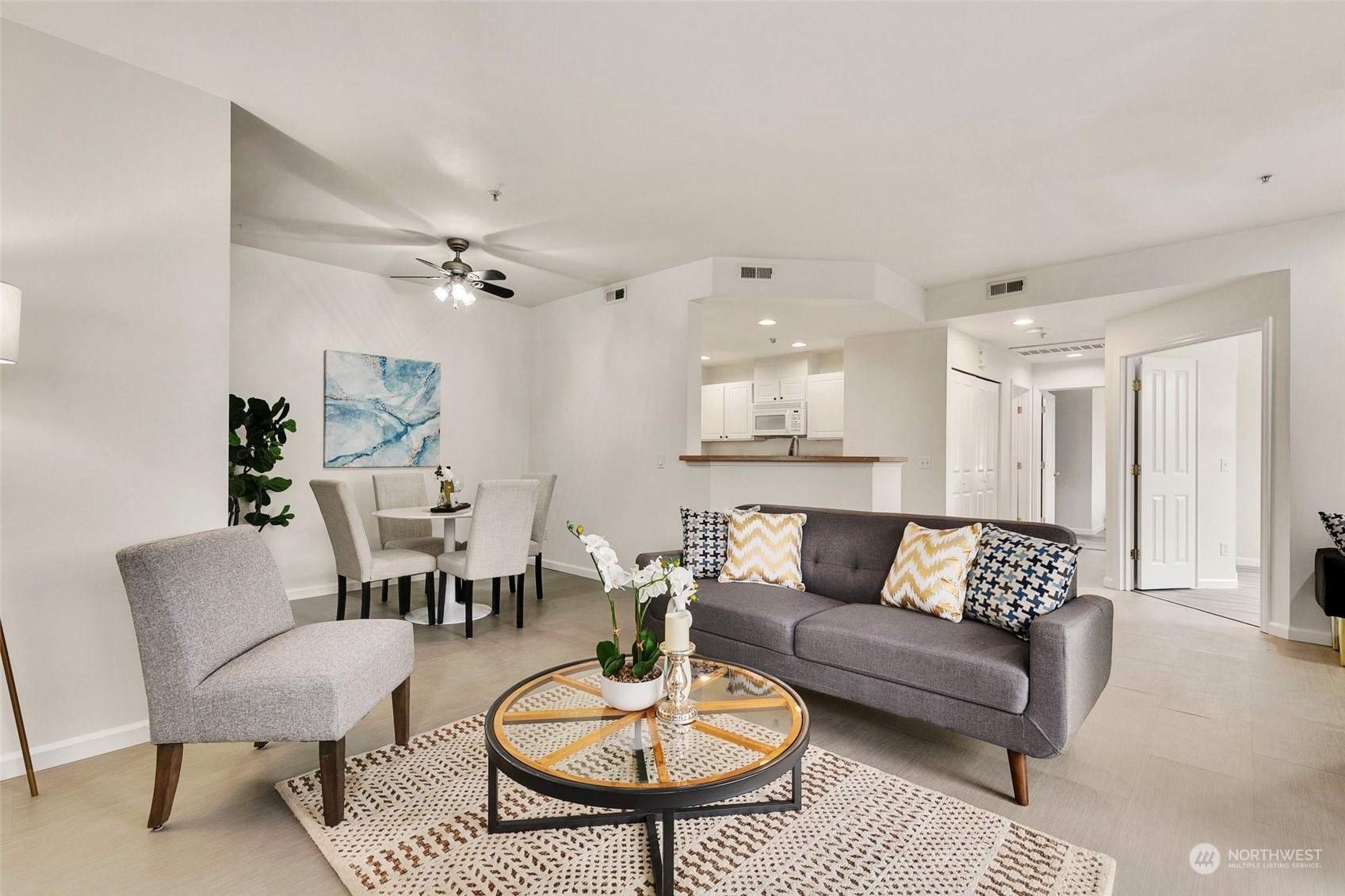 a living room with furniture and a chandelier