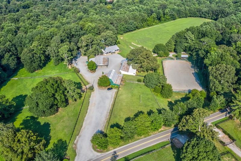 an aerial view of a house with a yard and outdoor seating