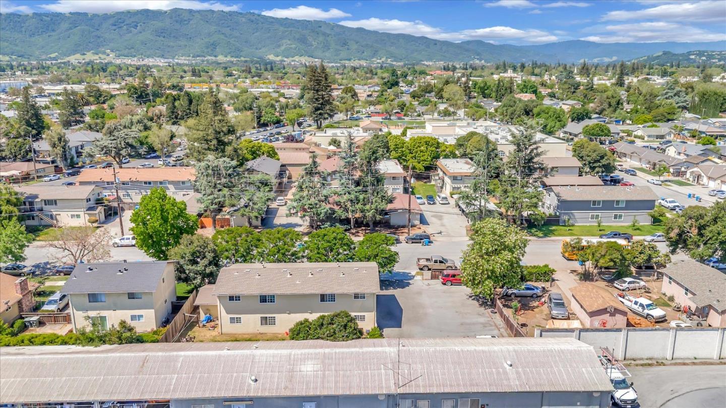 an aerial view of residential houses with outdoor space and street view