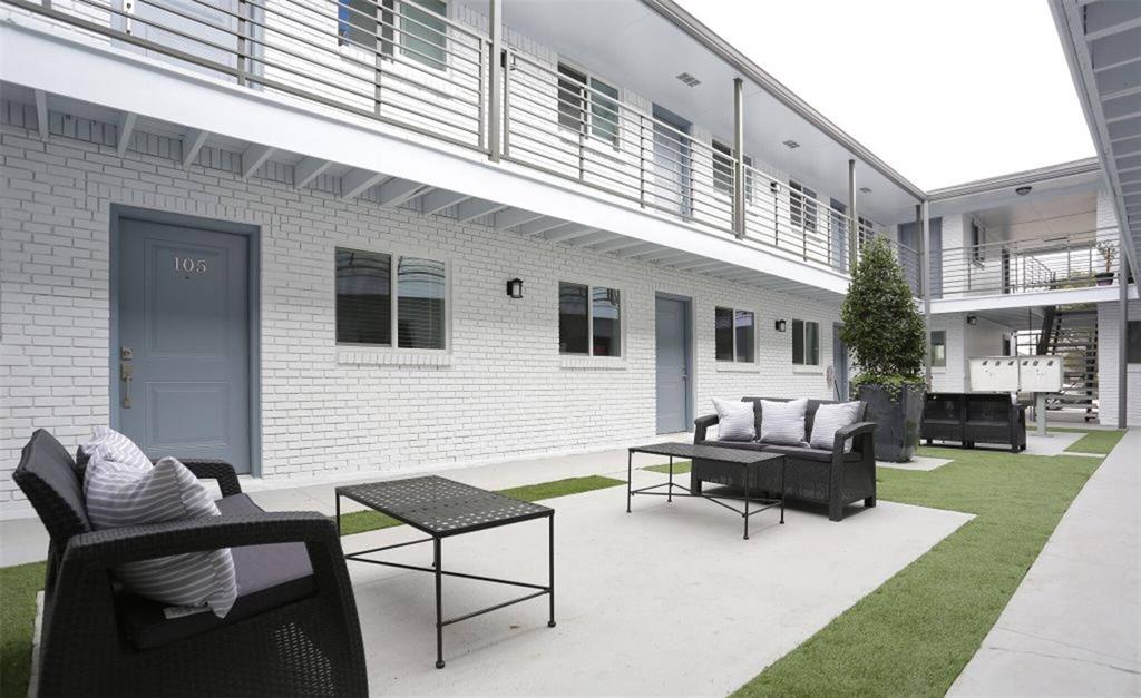 a view of a patio with couches chairs and a yard