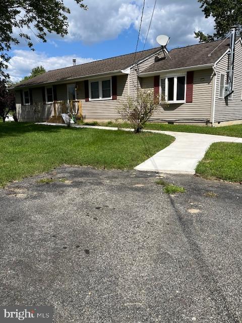 a front view of a house with a yard and potted plants