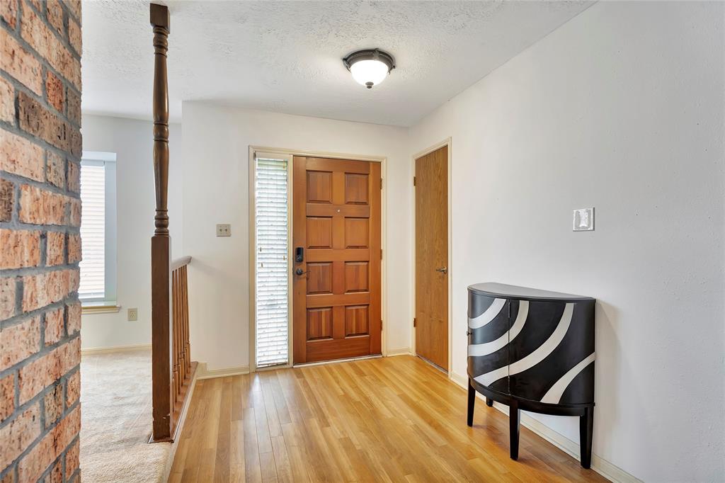 a view of an entryway with wooden floor