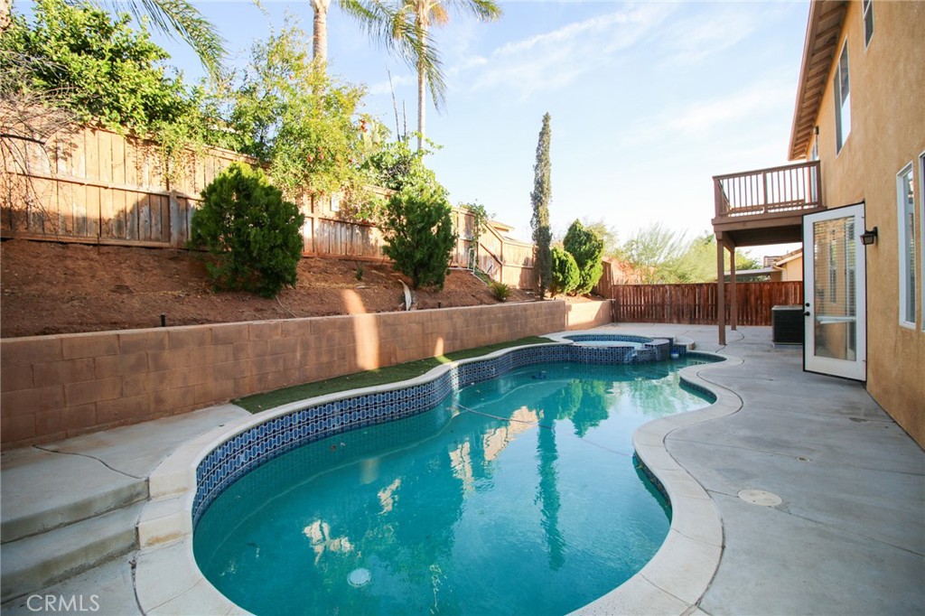 a view of a swimming pool with sitting area