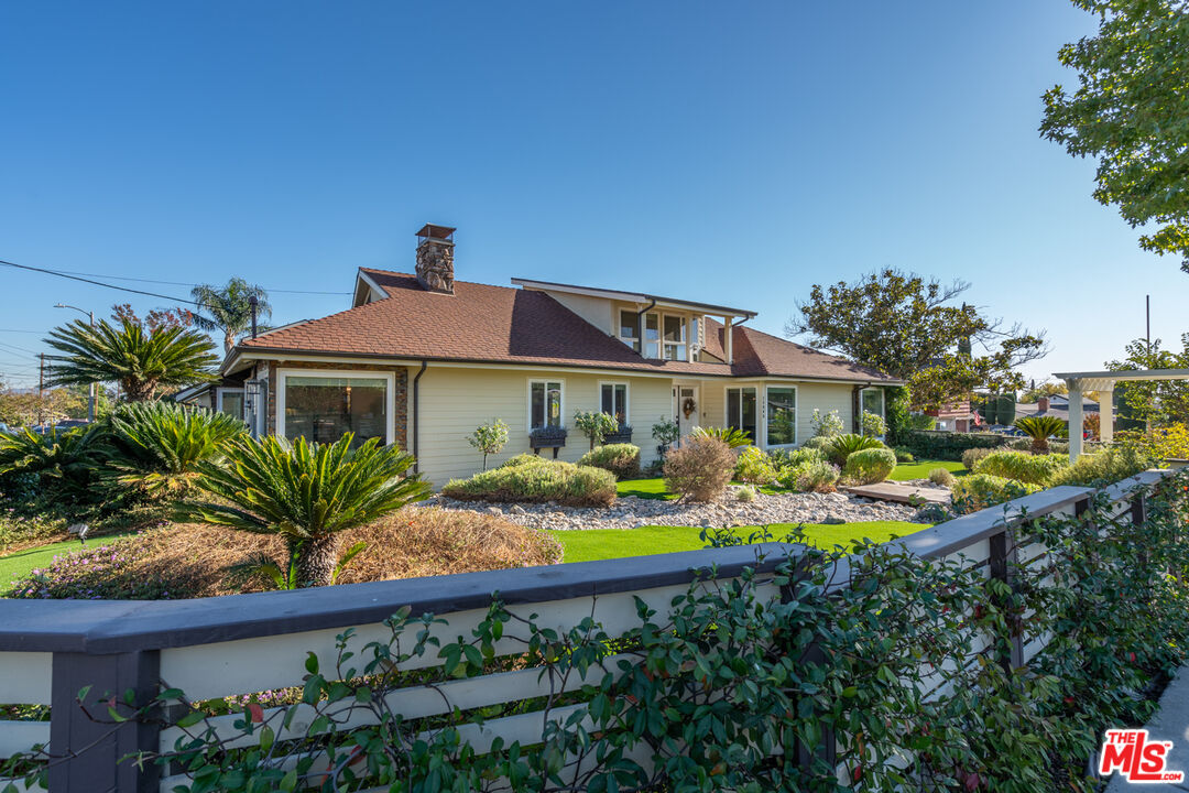 a front view of house with yard and outdoor seating