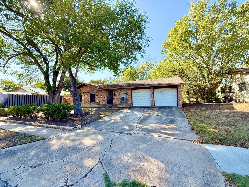 a view of a house with a large tree