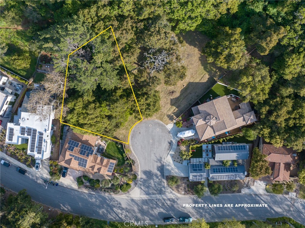 an aerial view of a house with a yard and lake view