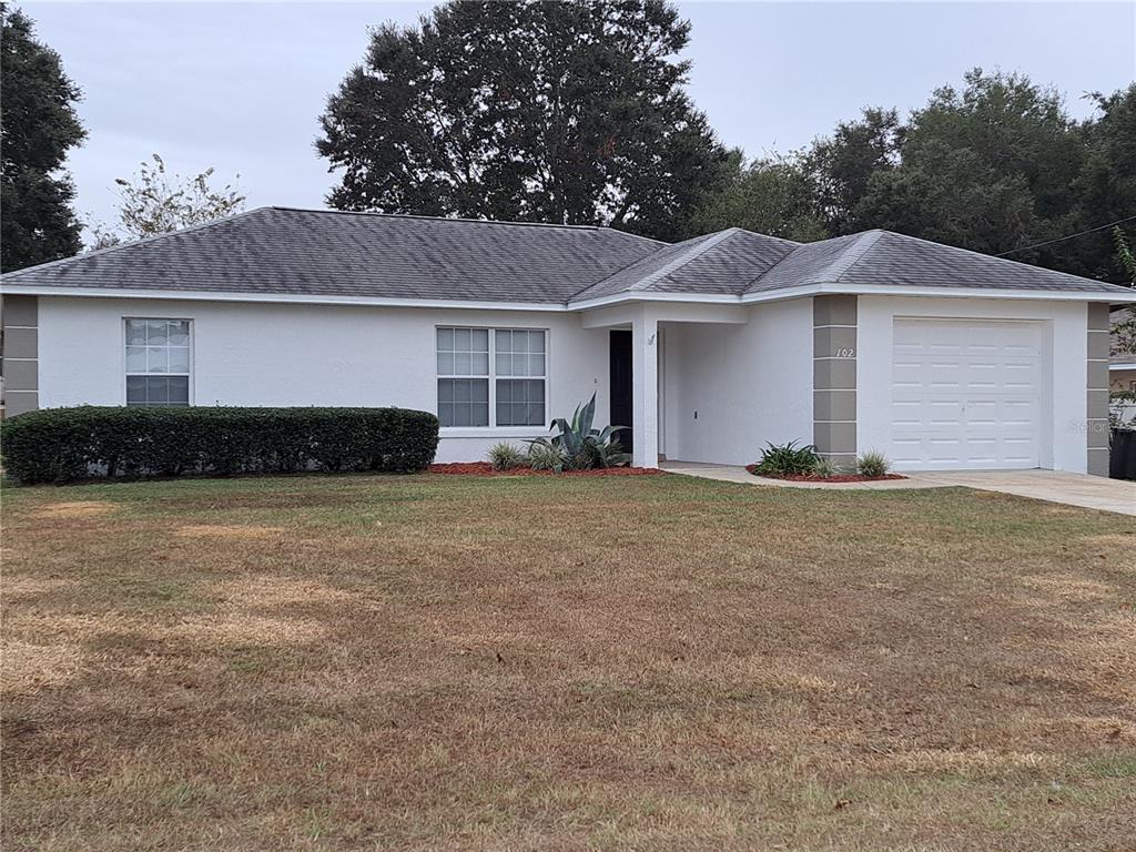 a front view of a house with a yard