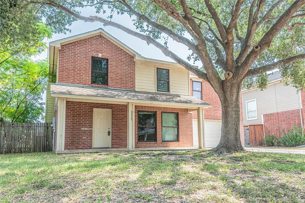 a house that has a tree in front of the house