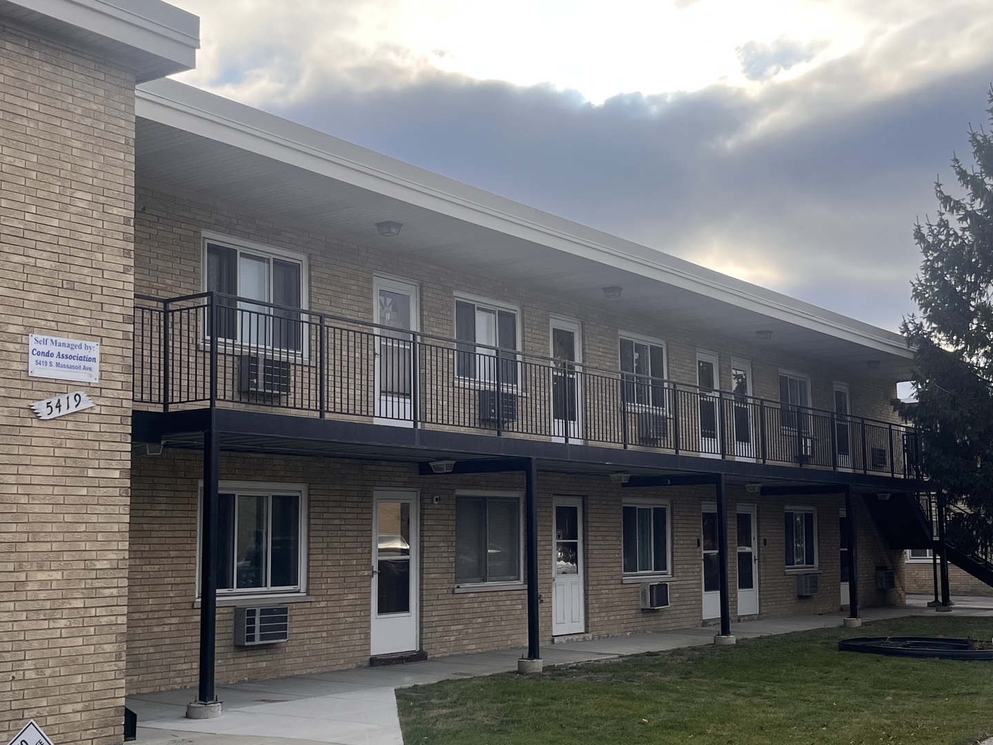 a front view of a residential apartment building with a yard