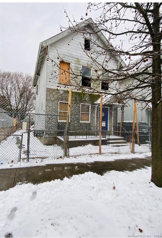 a view of a building with snow on the road