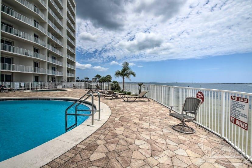 a view of a swimming pool with a lounge chair