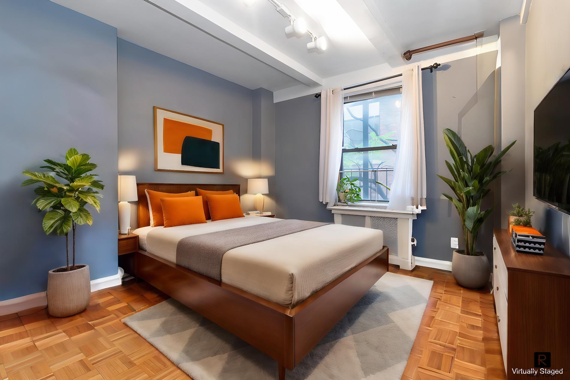 a bedroom with a large bed and a potted plant