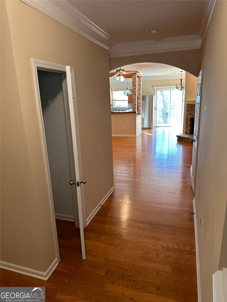 a view of empty room with wooden floor and floor to ceiling window