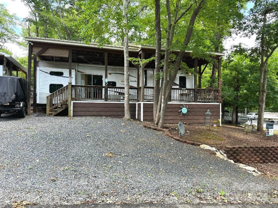 a view of a house with a yard and large tree