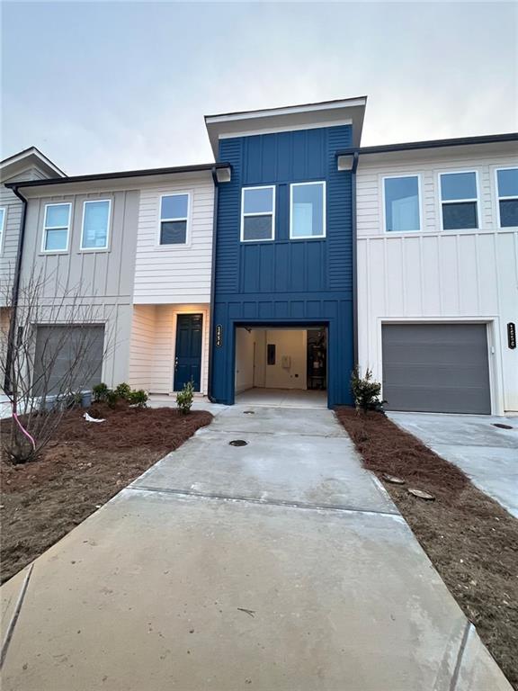 a front view of a house with yard and parking