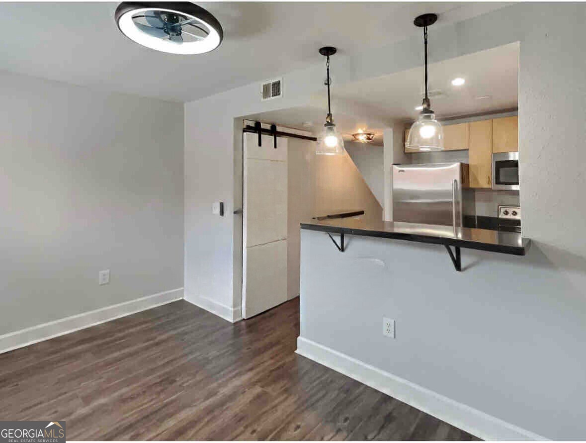 Dining Room - Breakfast bar with a spacious dining room. Pantry is nicely hidden behind handmade barn doors.