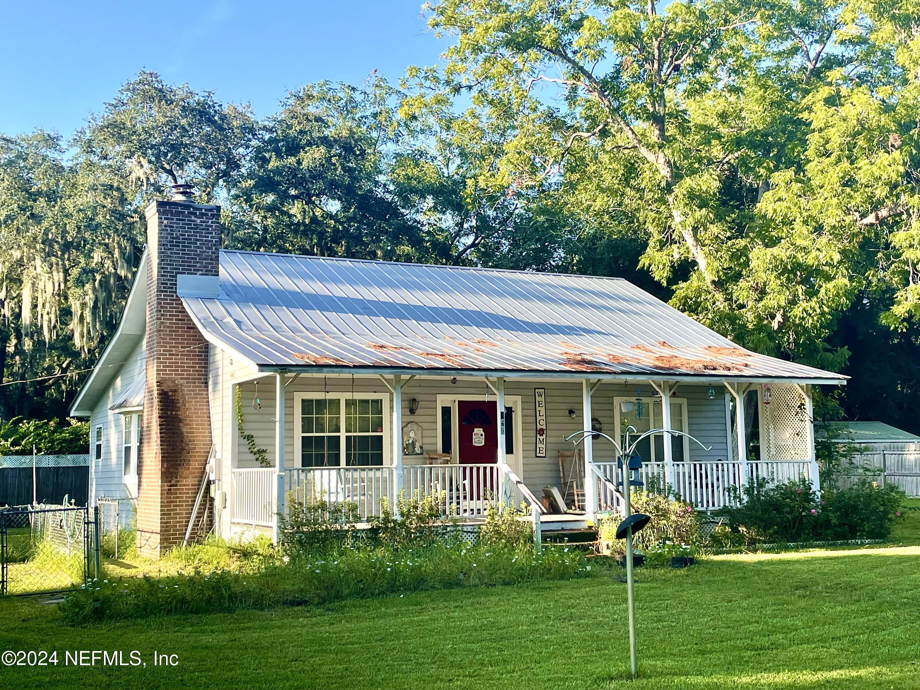 a front view of a house with garden and porch