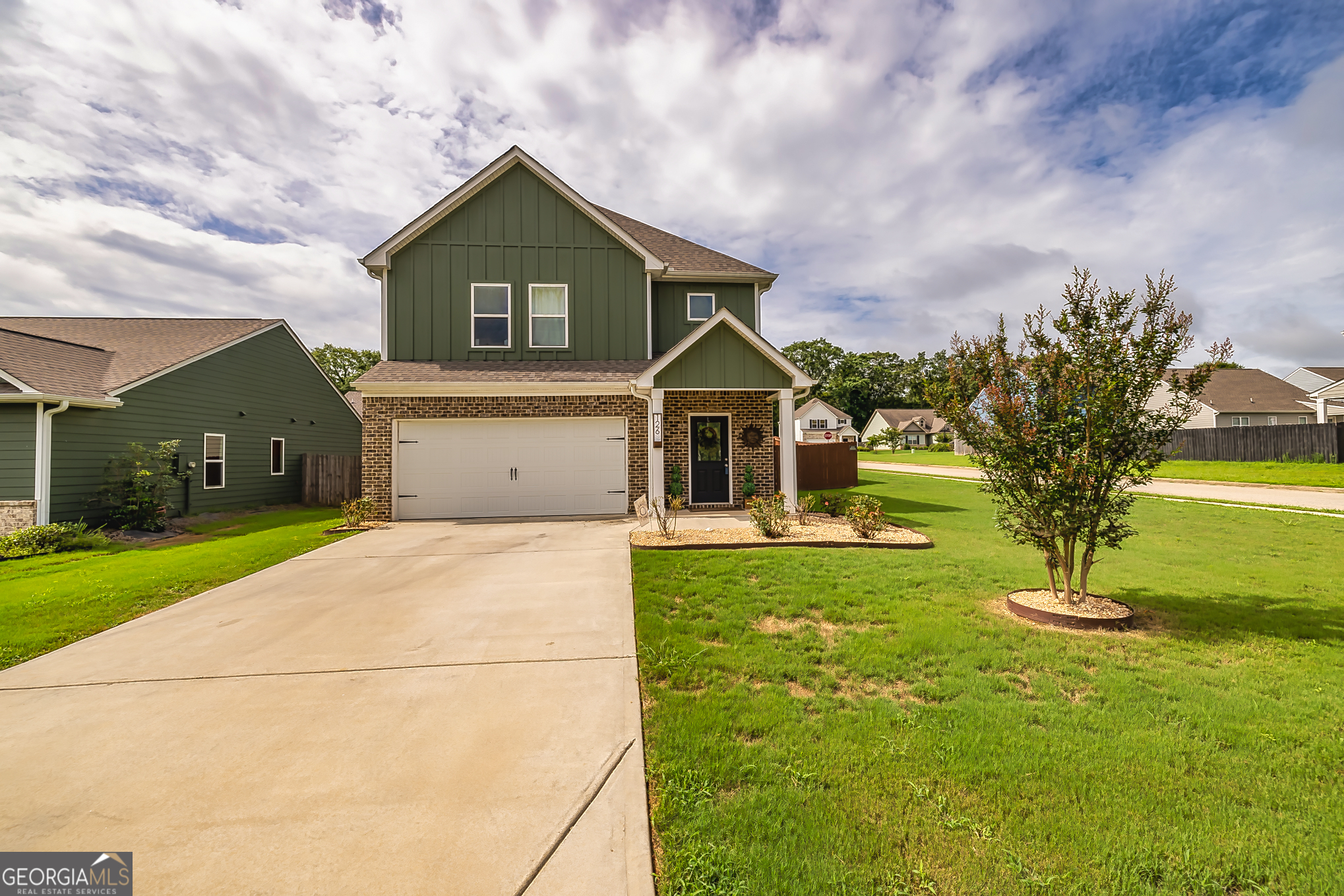 a front view of a house with a yard