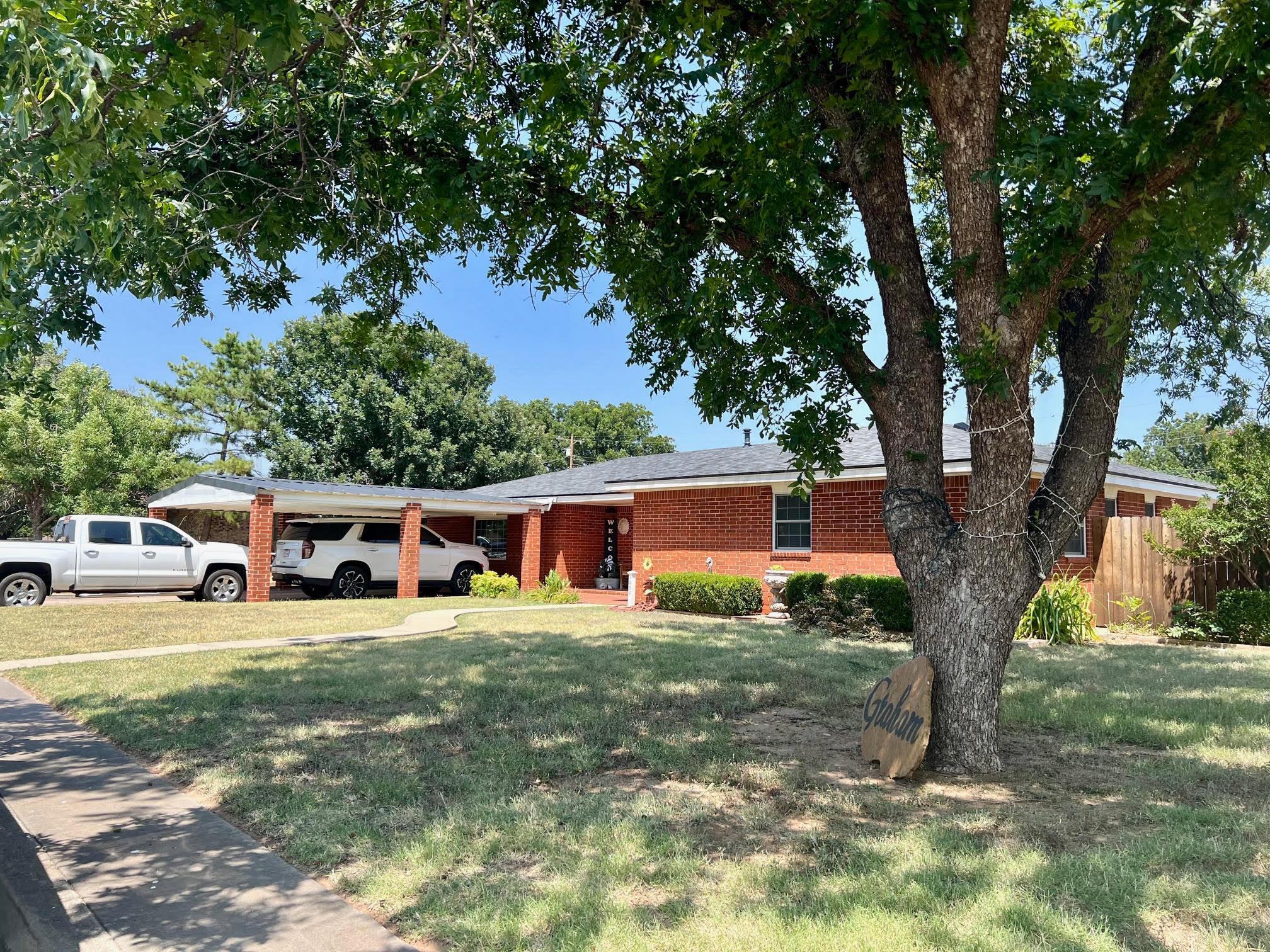 a view of a house with yard and sitting area