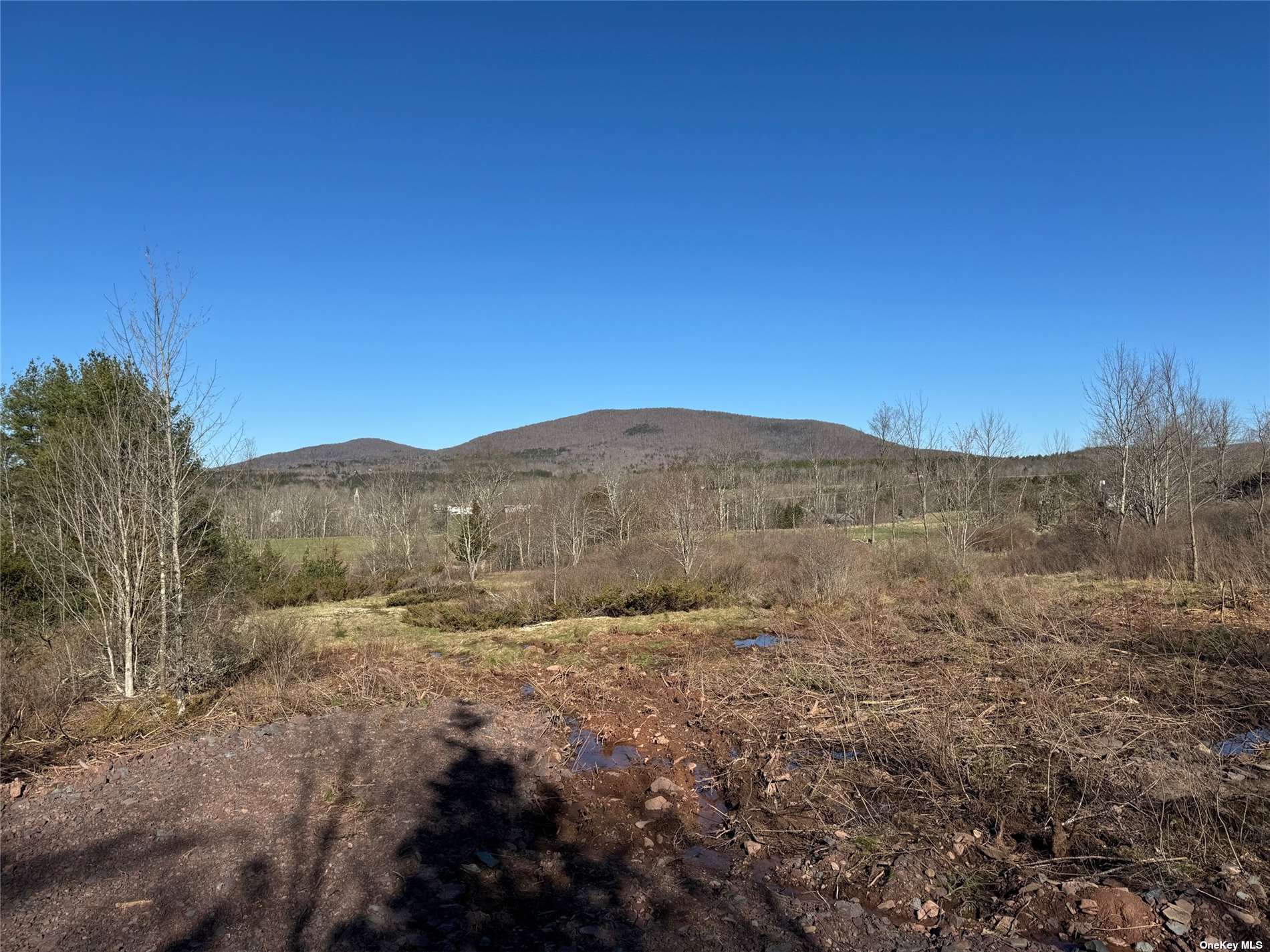 a view of a large mountain with mountains in the background