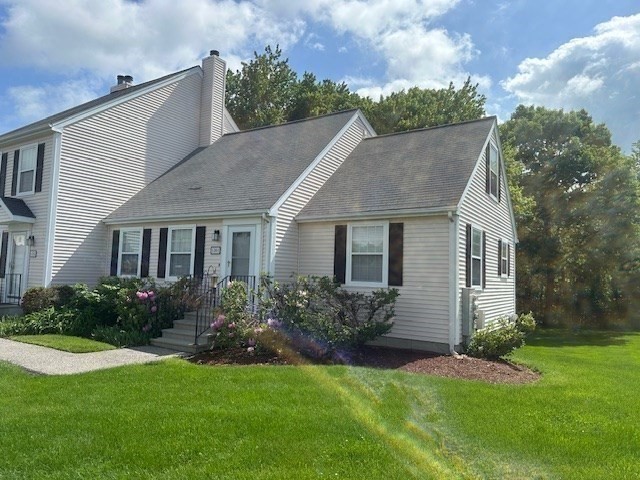 a front view of house with yard and green space