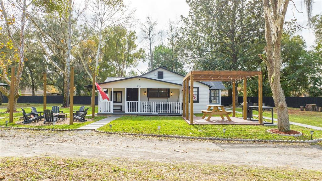 a front view of a house with a yard patio and fire pit