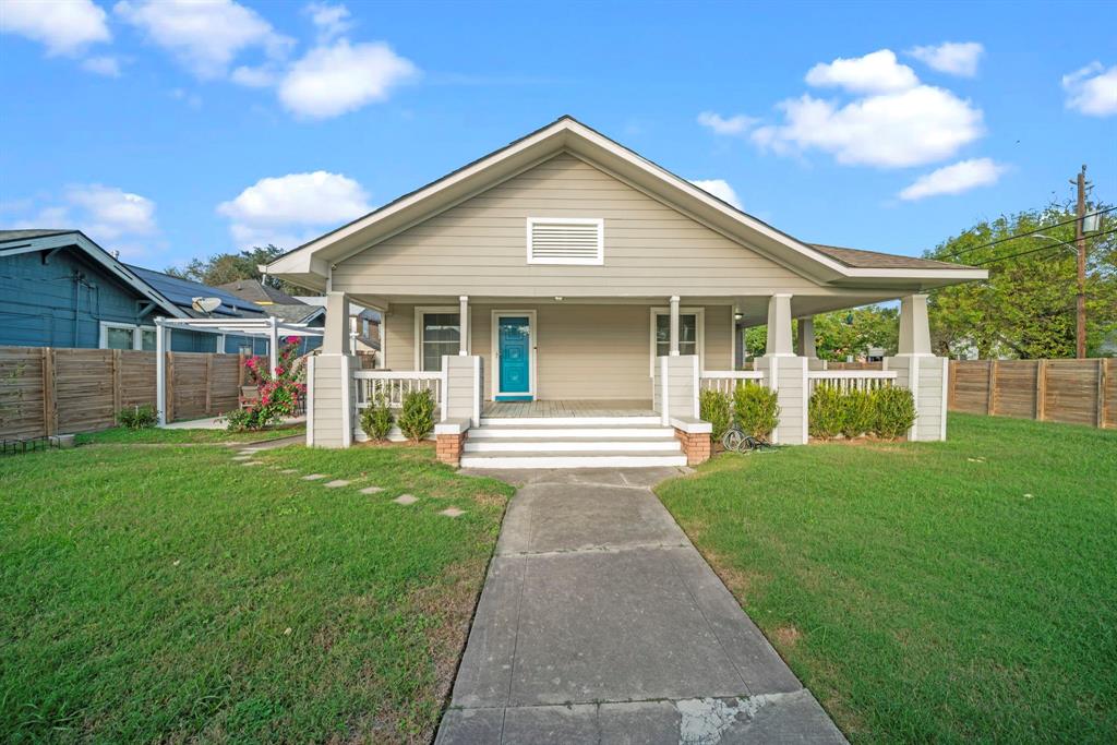 a front view of a house with a yard and garden