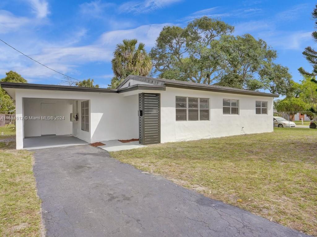 a view of a house with a yard and garage