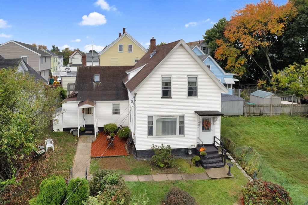 a view of a big house with a big yard and potted plants