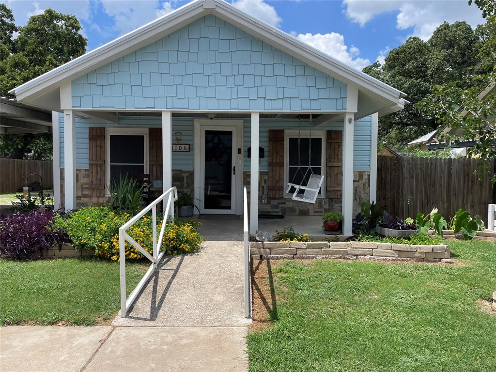 a view of house with a yard chair and table in the patio