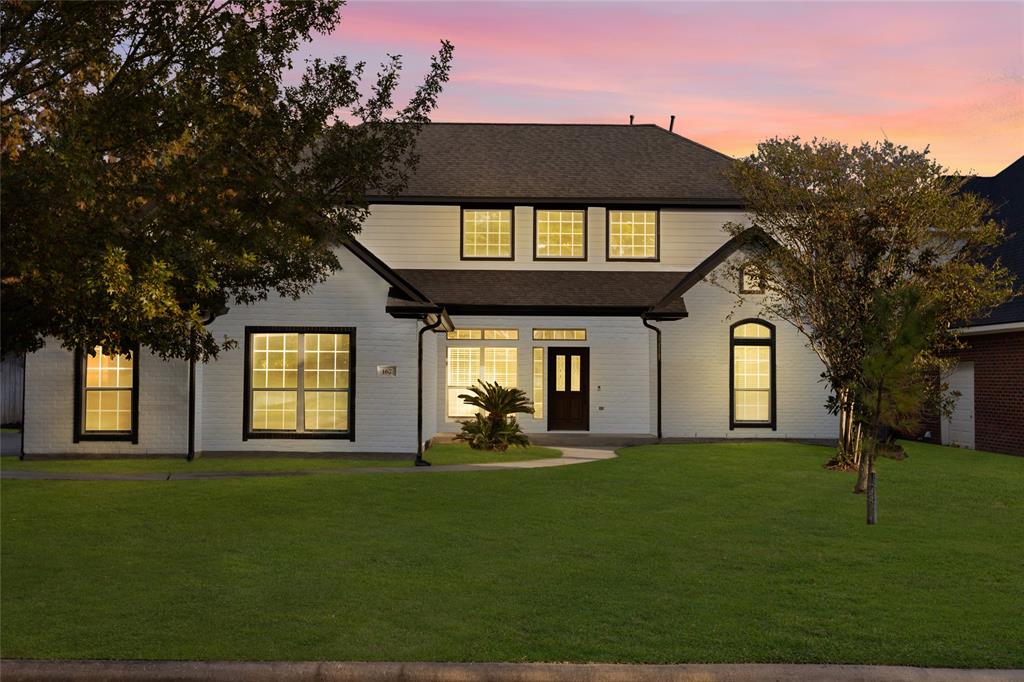 a front view of a house with a garden