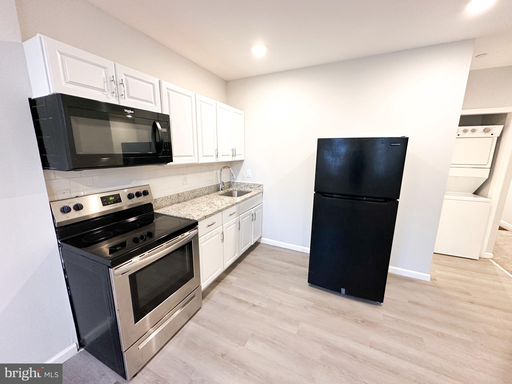 a kitchen with a refrigerator stove and microwave