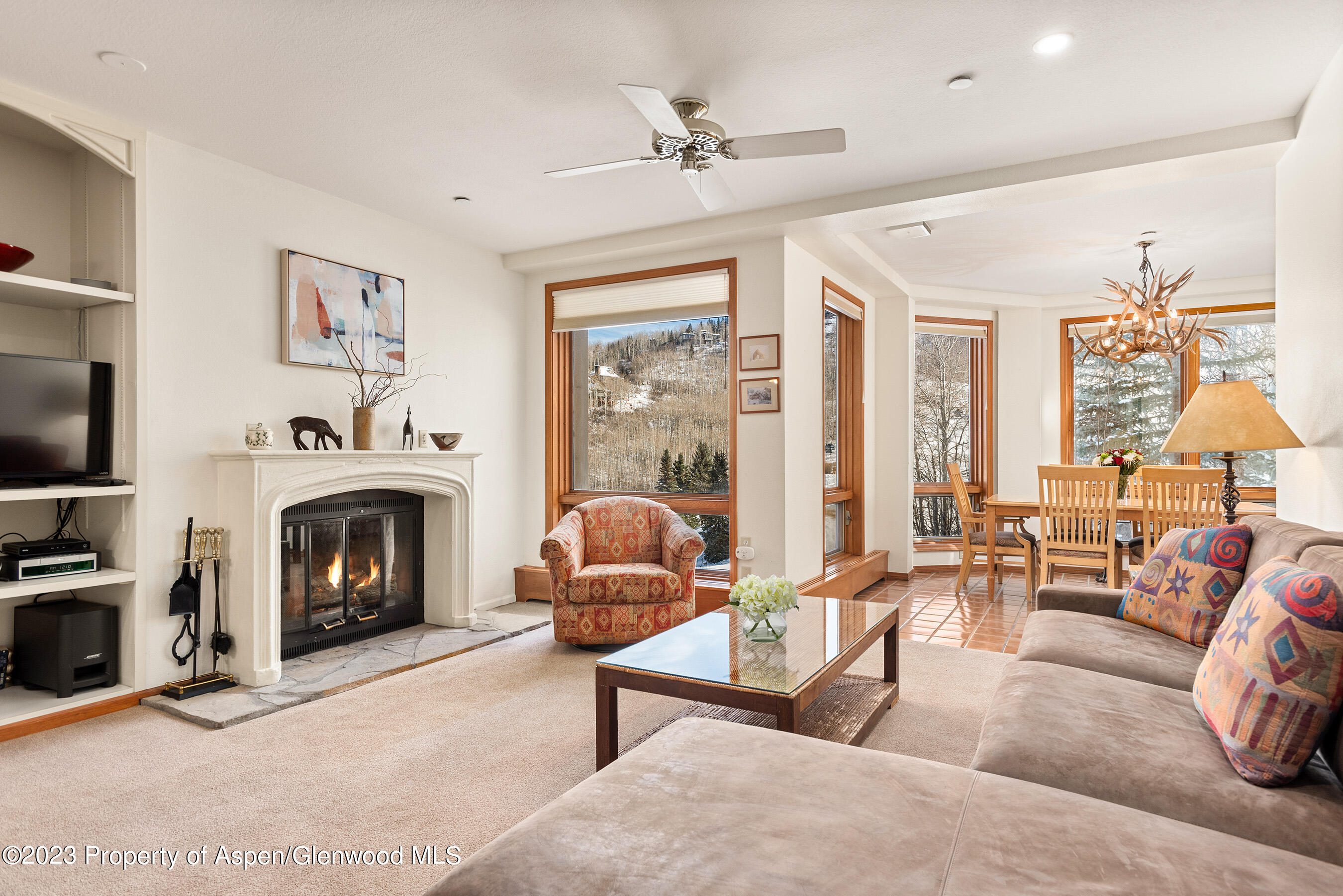 a living room with furniture large window and a fireplace