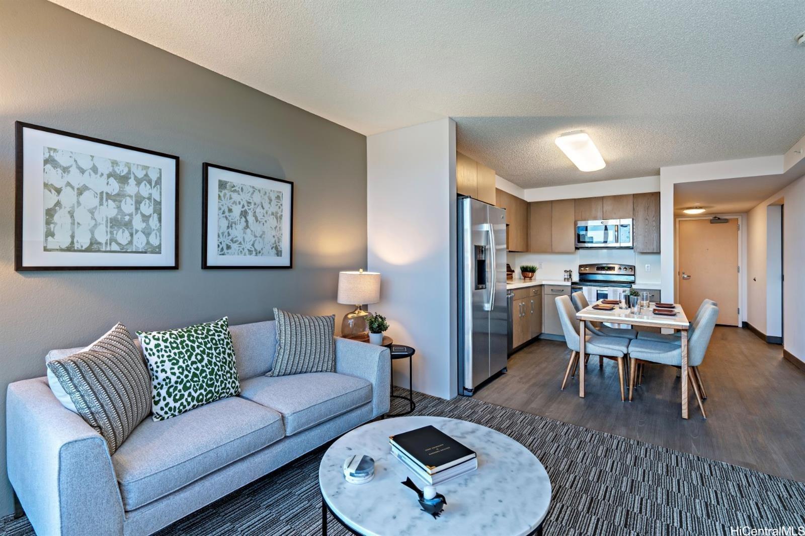 a living room with furniture kitchen view and a table