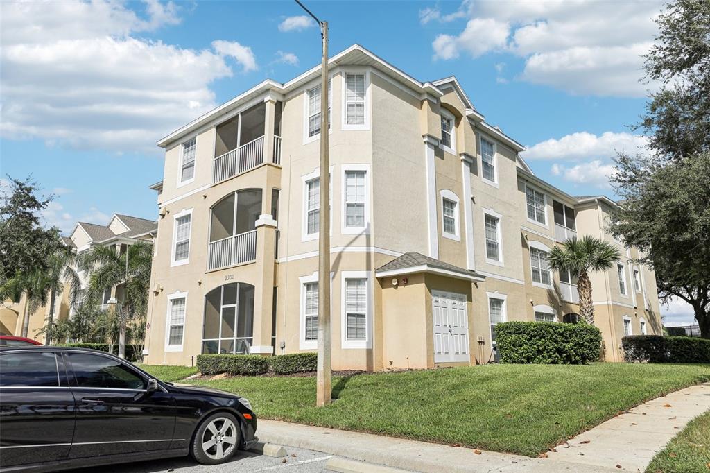 a front view of a residential apartment building with yard