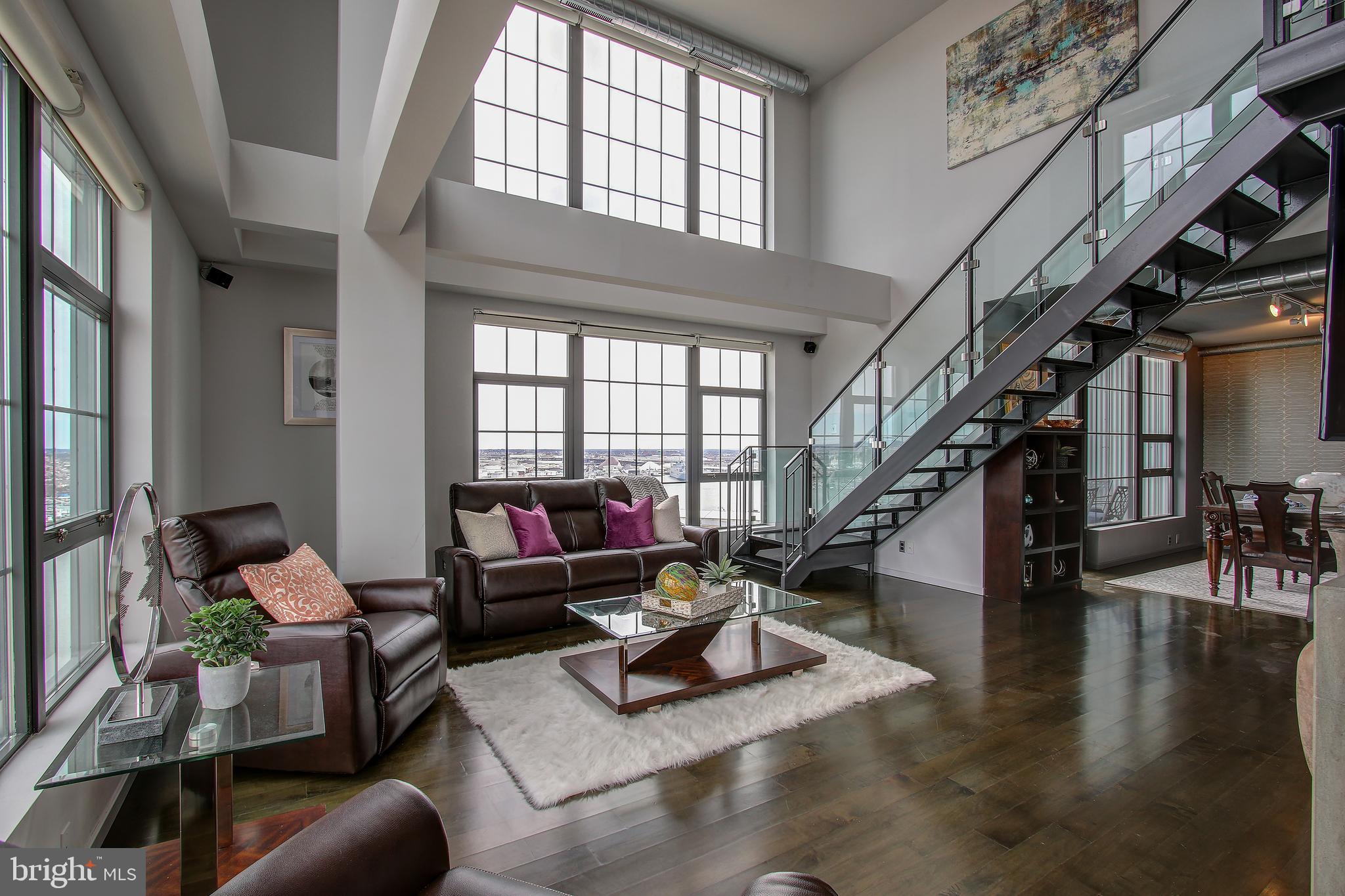 a living room with furniture or stairs and a wooden floor