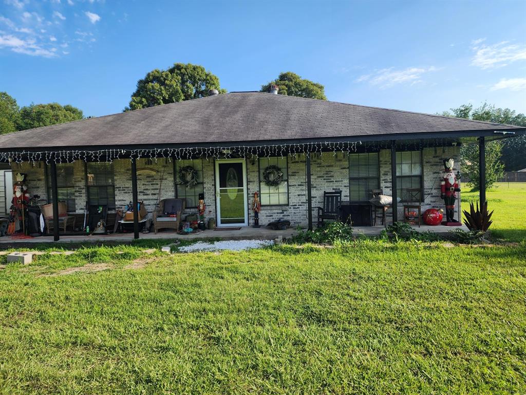 a view of a house with backyard porch and furniture